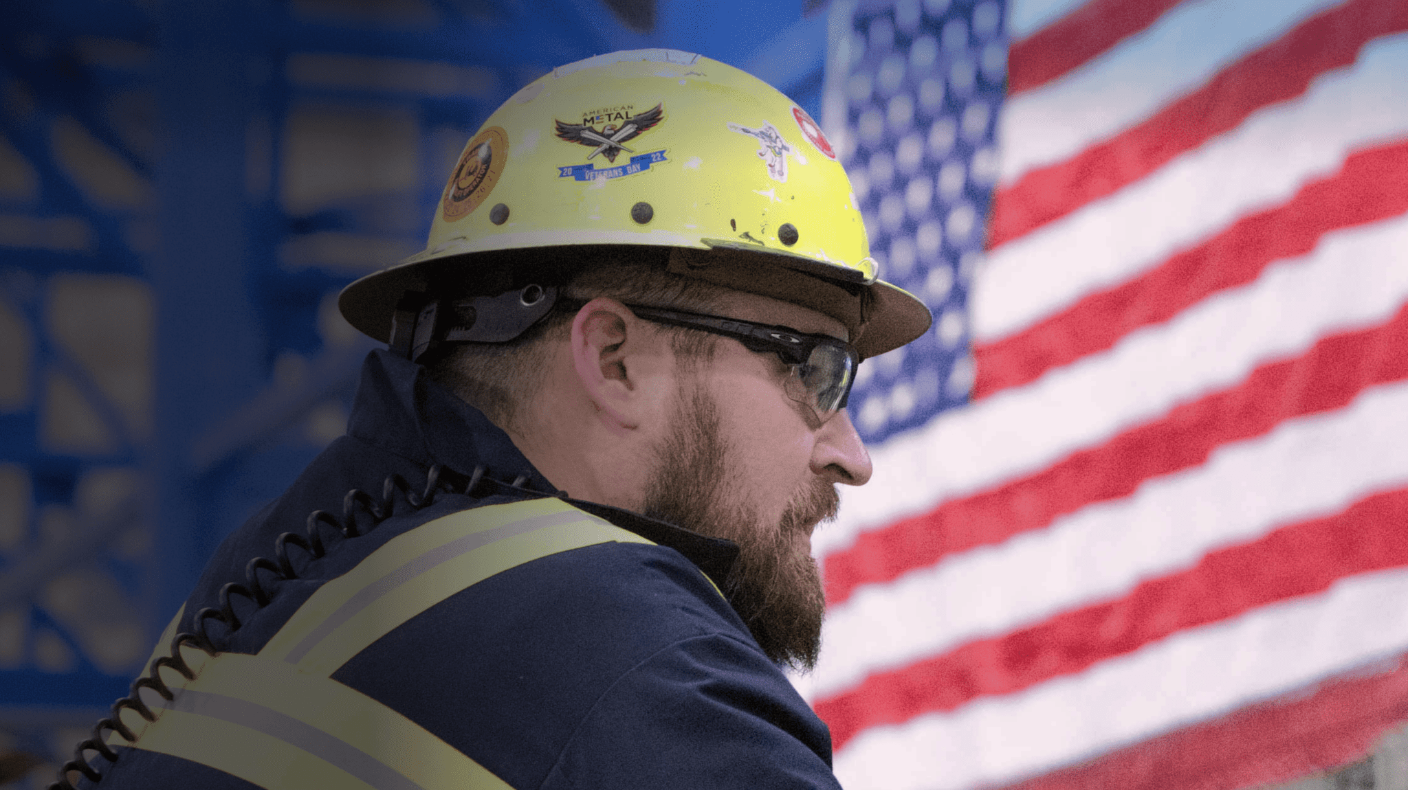 Worker with American flag behind